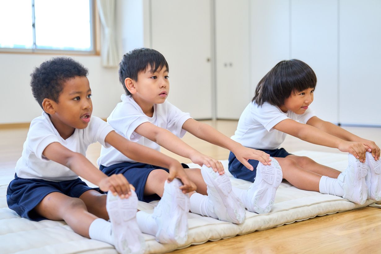 Children Stretching in Gym Class